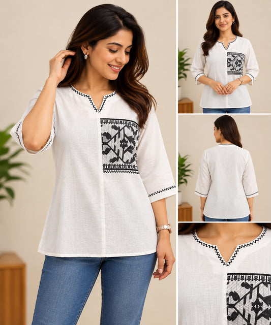 White cotton short top with black tribal print panel, V-slit neckline, and three-quarter sleeves with black zigzag detailing.