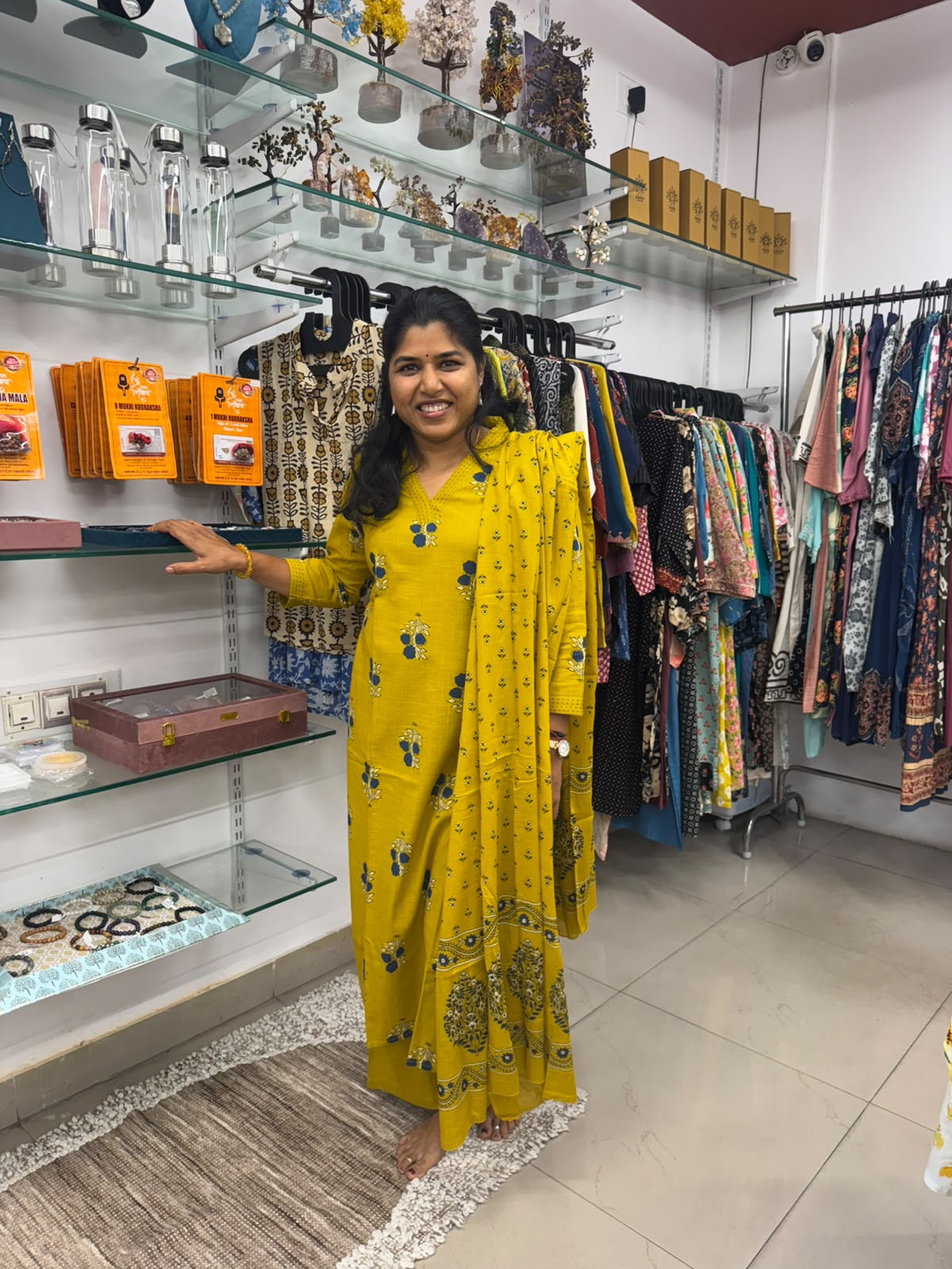Mustard yellow kurta pant set with blue and cream floral prints and matching dupatta featuring a decorative border.
