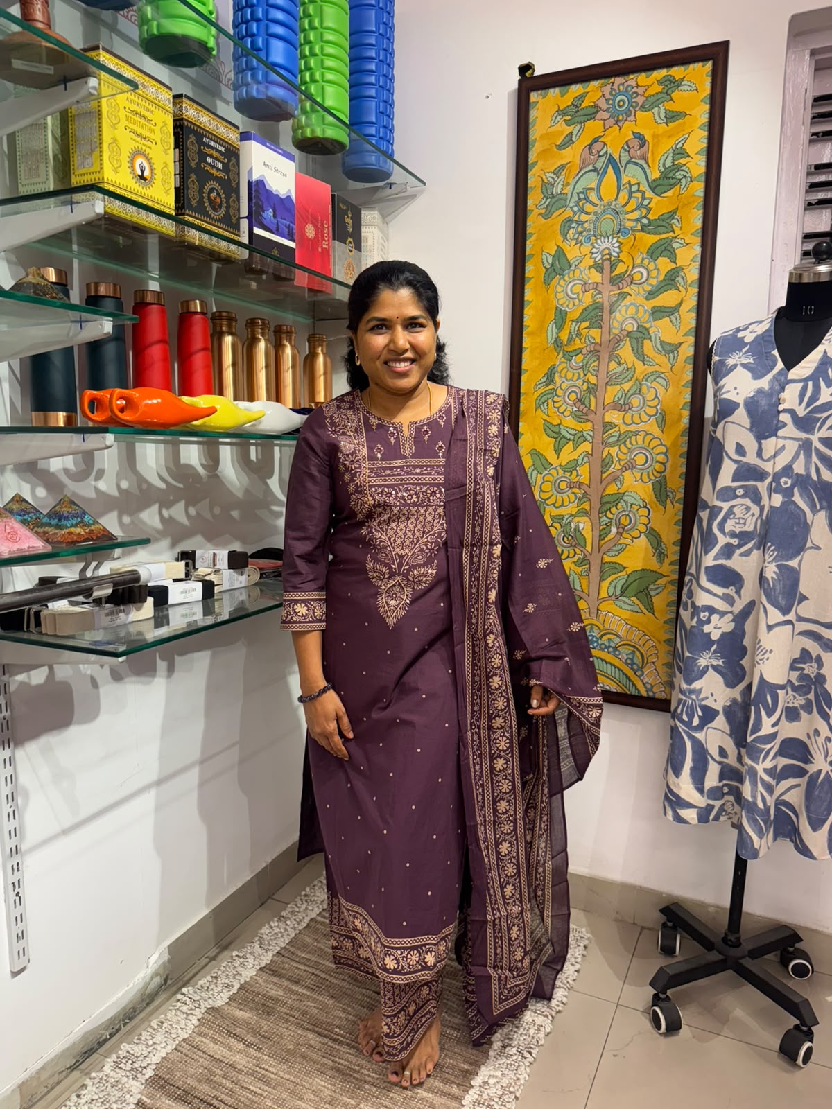 Purple cotton embroidered kurta pant set with beige-gold floral detailing and matching dupatta on a female model.