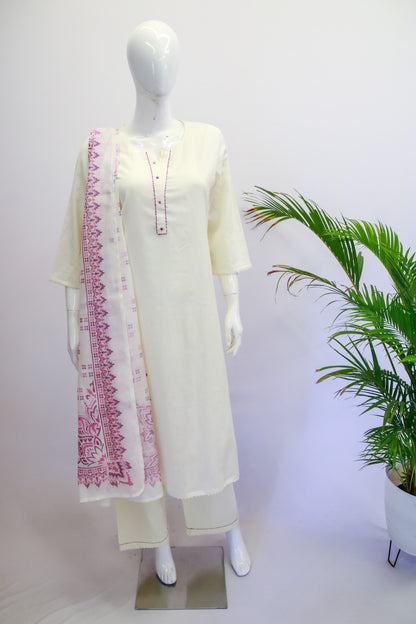 White kurta with pink embroidery on a mannequin against a white background with a plant.
