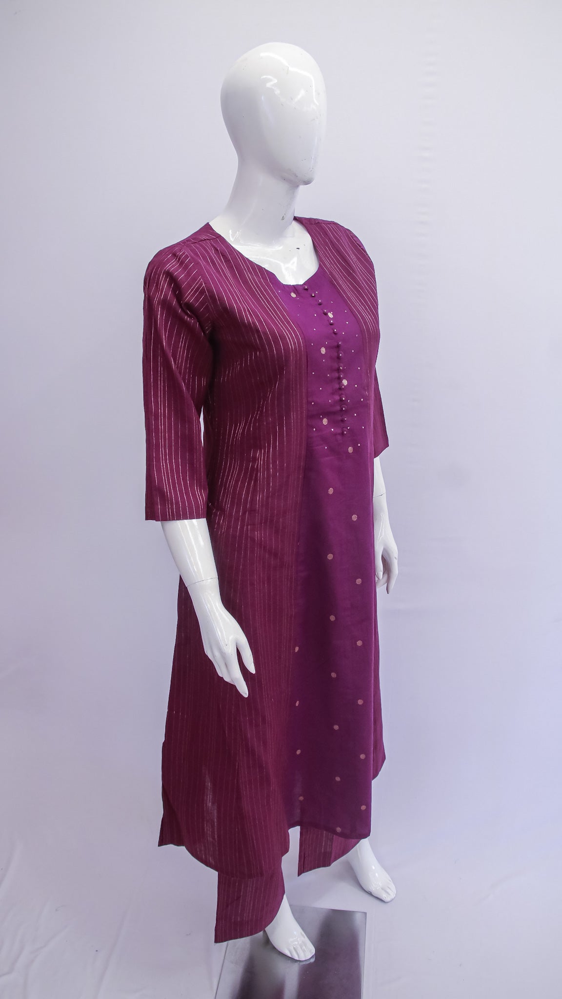 Mannequin wearing a long burgundy dress with a white background