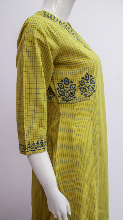 Yellow checkered dress with embroidery on a mannequin against a white background