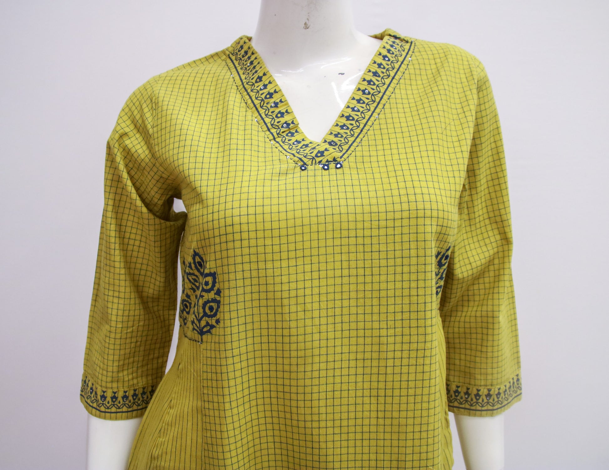 Yellow checkered kurta with embroidery on a white background