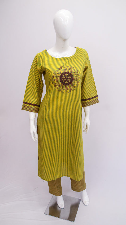 Yellow dress with brown pattern on a mannequin against a white background